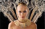 beautiful portrait of attractive blond woman like an amazon with a necklace made of wood peg