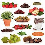 Healthy food collection of fruit, nuts, herbs and pulses, very high in antioxidants and vitamins, isolated over white background.