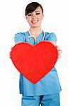 Stock image of female health care worker holding heart
