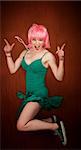 Disco dancing woman in green dress and pink hair