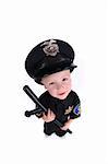 Funny Adorable Image of a Child Police Officer Holding a Night Stick