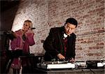 Cool DJ with turntable and blonde keyboardist