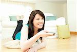 Joyful woman watching television in the living room