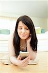 Caucasian woman listening music lying on the floor at home