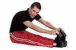 Fitness men stretches his leg before and exercising over white background