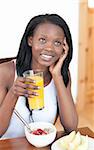 Charming Afro-American having breakfast in the living-room