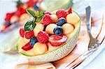 Delicious fresh fruits served in melon bowl as dessert