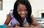 Positive Afro-american woman studying at home