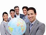 Victorious business team holding a terrestrial globe against a white background