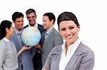 Successful business team holding a terrestrial globe against a white background