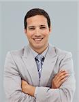 Attractive businessman with folded arms smiling at the camera