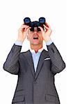 Surprised businessman looking through binoculars against a white background