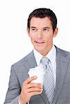 Assertive businessman holding a drinking cup against a white background