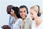 Smiling business people working in a call center in the office