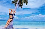 Beautiful woman resting on beach at Maldives