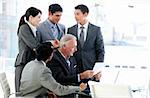 Multi-ethnic business team studying a document in a meeting