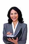 Charming businesswoman making notes on her agenda isolated on a white background