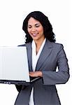 Cheerful businesswoman using a laptop at work