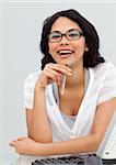 Portrait of a brunette businesswoman wearing glasses in her office