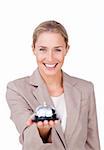 Smiling businesswoman holding a bell isolated on a white background