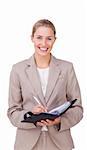 Assertive businesswoman making notes on her agenda isolated on a white background