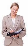 Young businesswoman making notes on her agenda isolated on a white background