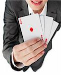 Close-up of a businesswoman holding all the aces against a white background