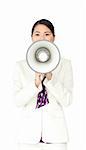 Angry businesswoman shouting through megaphone outdoors