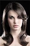desaturated fashion portrait of beautiful sensual woman with elegant hairstyle over black background