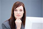 Confident businesswoman working at a computer in the office