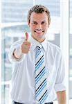 Portrait of a charismatic businessman with a thumb up in the office