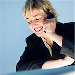 Caucasian businesswoman smiling talking on cellphone.