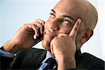 African American businessman holding cellphone to ear.