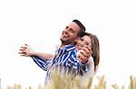 Couple enjoying the breeze with eachother hand stretched in the park