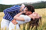 Men and woman hugging in the meadow