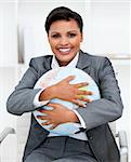 Charismatic businesswoman holding a terrestrial globe in the office