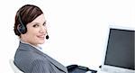 Confident businesswoman with headset on sitting at her desk in the office