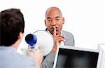 Afro-american businessman asking for silece while his colleague yelling through a megaphone in the office