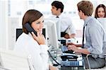 Enthousiastic businesswoman talking to the phone in the open-space