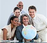 United businessteam holding a globe in the office globalization concept