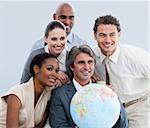 Multi-ethnic businessteam holding a globe in the office of the company