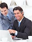 Two businessmen working at a computer in the office