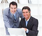 Close-up of two businessmen working at a computer in the office