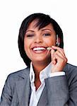 Businesswoman with headset on smiling at the camera against a white background