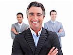 Enthusiastic businessman posing in front of his team against a white background