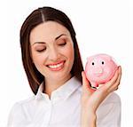 Confident businesswoman holding a piggybank isolated on a white background
