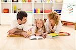 Little girl practice reading with her parents