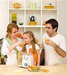 Happy healthy family drinking freshly squeezed orange juice