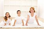 Happy healthy kids and their mother doing gymnastic exercises - healthy life concept