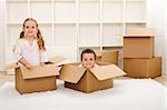 Kids in their new home having fun with cardboard boxes